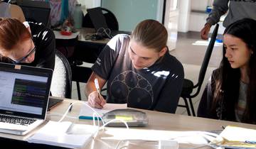 EGOI organizer Stefanie Zbinden working with Priska and Vivienne during the Informatics Olympiad's "Girls Camp" 2020 (Images: Informatics Olympiad)