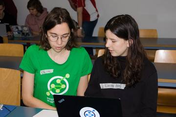 Picture of Charlotte helping a participant, Berne